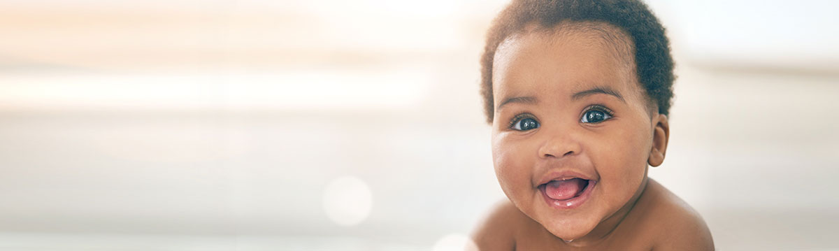 An African American baby boy smiling.